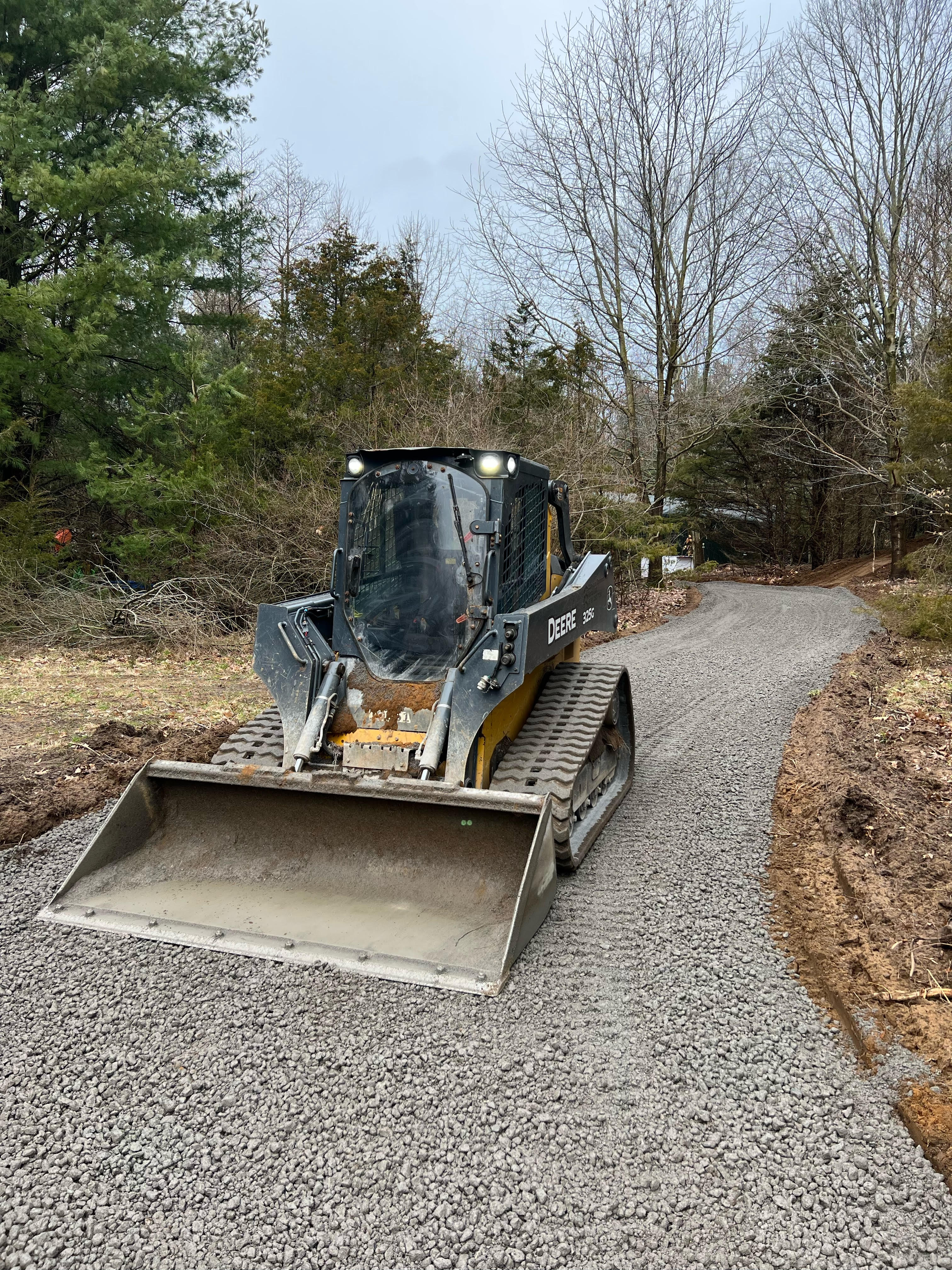 Skid steer on gravel driveway
